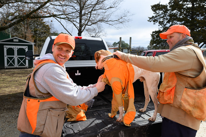 Fieldskin® Founder, Ben Field putting protective dog suit on dog